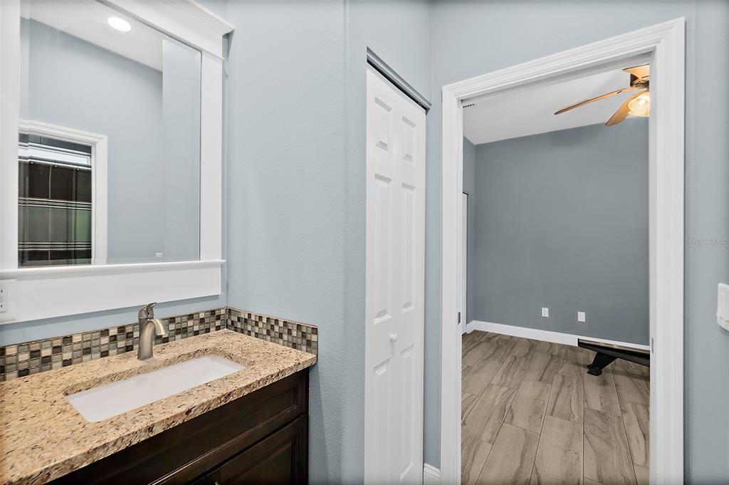 4895 State Rte 100 Bunnell, FL 32110 - Photo 27 of 45 a bathroom with a granite countertop sink and a mirror