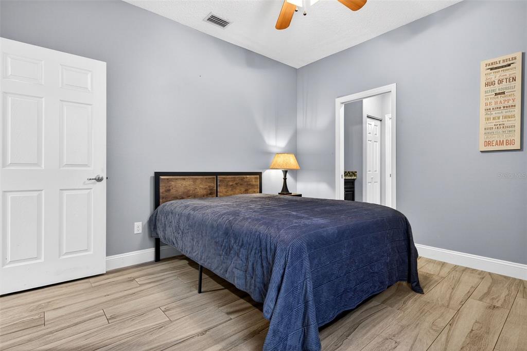 4895 State Rte 100 Bunnell, FL 32110 - Photo 30 of 45 a bedroom with a bed and wooden floor