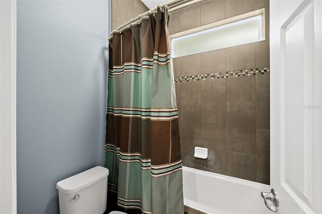 4895 State Rte 100 Bunnell, FL 32110 - Photo 31 of 45 a bathroom with a toilet and a shower