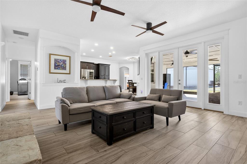 4895 State Rte 100 Bunnell, FL 32110 - Photo 8 of 45 a living room with couches and kitchen view with wooden floor