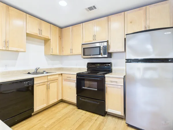a kitchen with a refrigerator sink and microwave