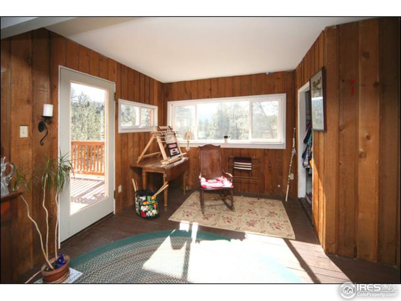 10940 Rist Canyon Road Bellvue, CO 80512 - Photo 8 of 18 a living room with furniture a large window and wooden floor