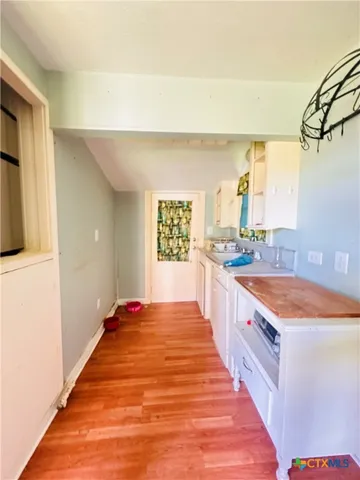 a living room with wooden floor and furniture