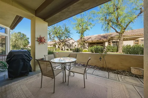 a view of balcony with a couple of chairs and a table