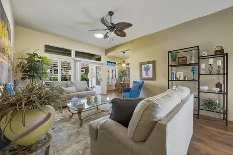 a living room with furniture gym equipment and a chandelier