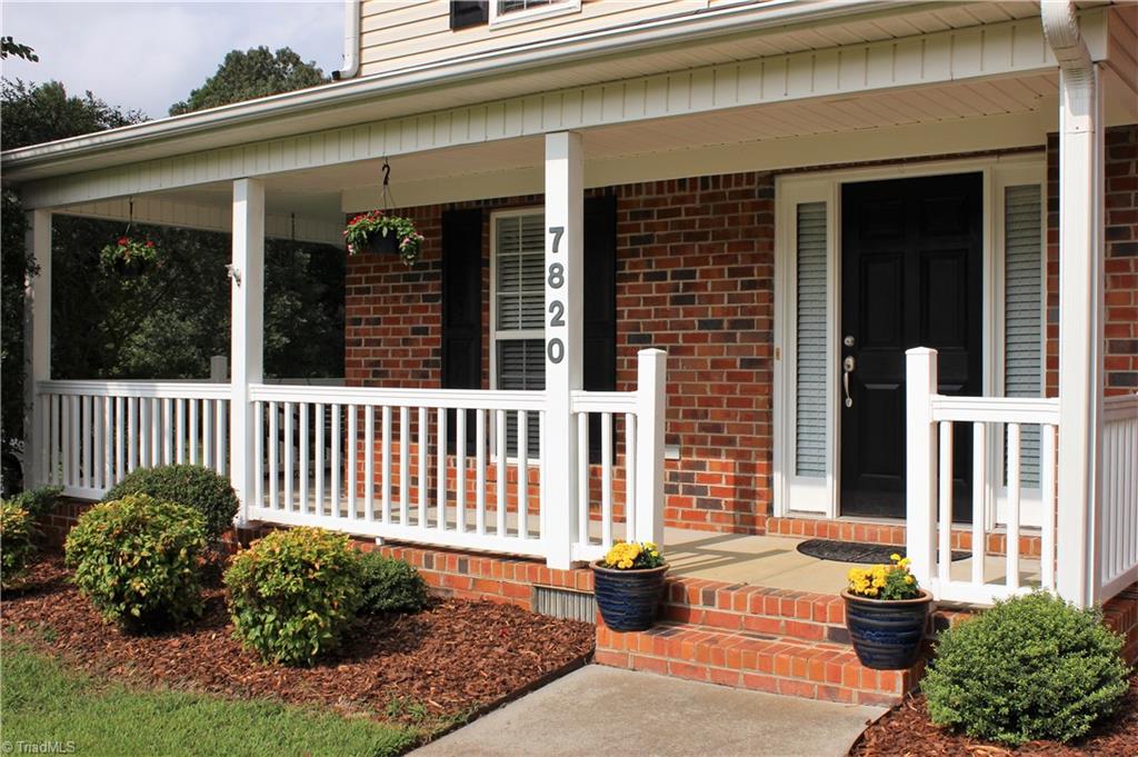 7820 Wilson Farm Road Summerfield, NC 27358 - Photo 2 of 29 The porch wraps around slightly & offers a porch swing!