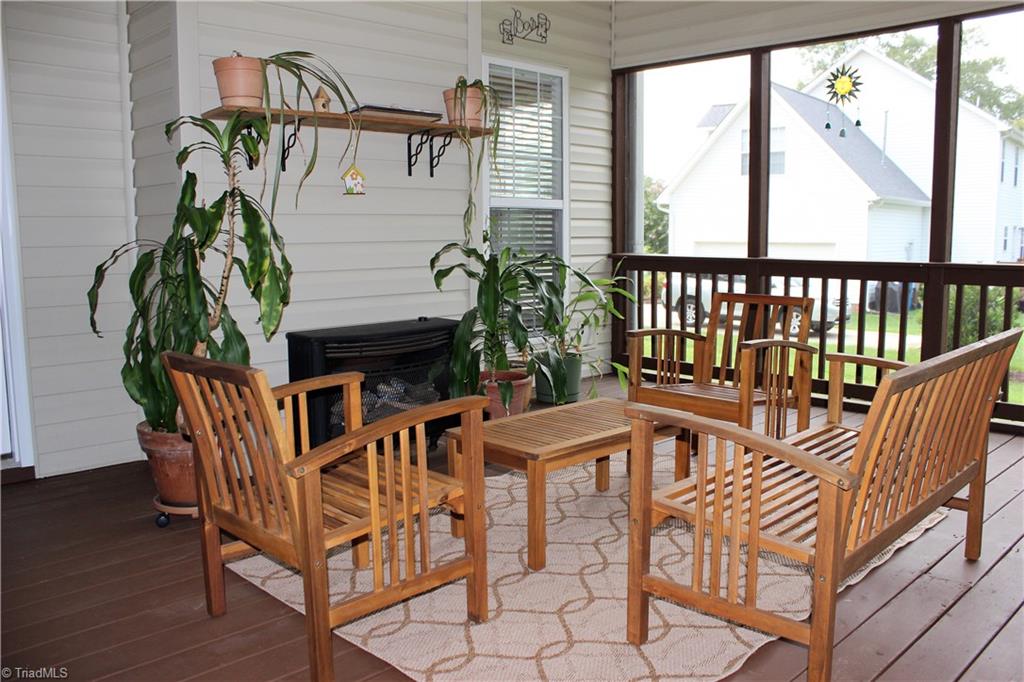 7820 Wilson Farm Road Summerfield, NC 27358 - Photo 24 of 29 Enjoy your Screened Porch anytime of the year with your Gas Fireplace!