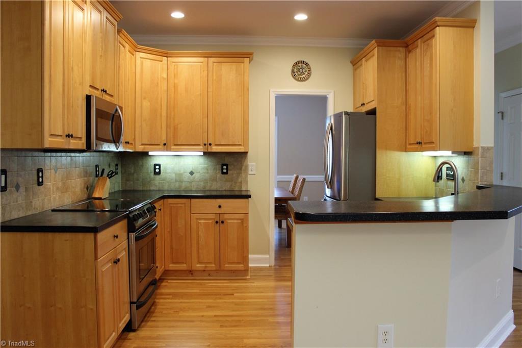7820 Wilson Farm Road Summerfield, NC 27358 - Photo 8 of 29 Ample Cabinets & Counterspace, Stainless Steel Appliances remain! Solid Surface Counters!