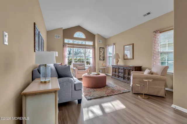a view of a dining room with furniture and chandelier