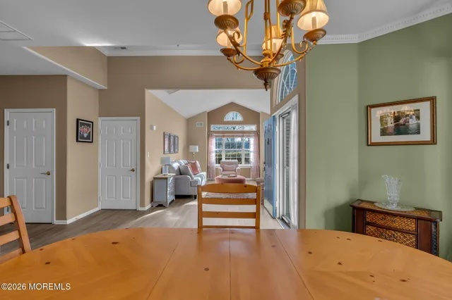 a spacious bedroom with a bed a dresser and a window
