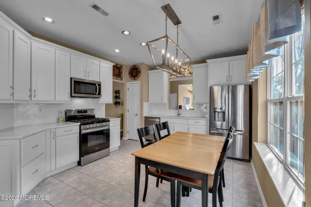 a front view of a house with a garden and trees