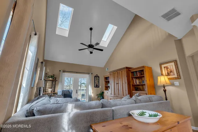 an aerial view of a house with garden space and a swimming pool