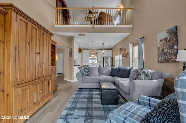 an aerial view of a city with lots of residential buildings and mountain view in back