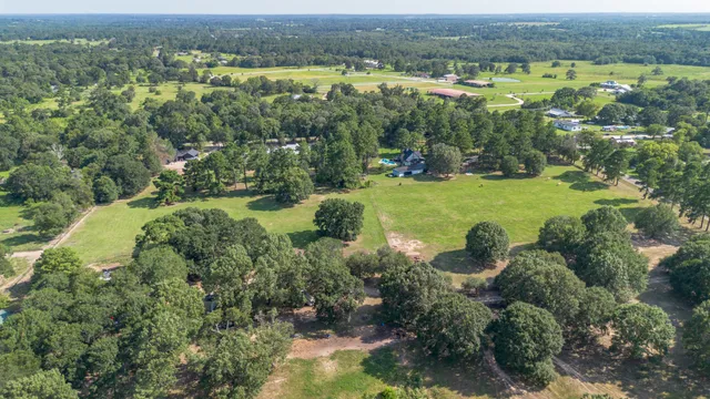 an aerial view of a houses with a yard