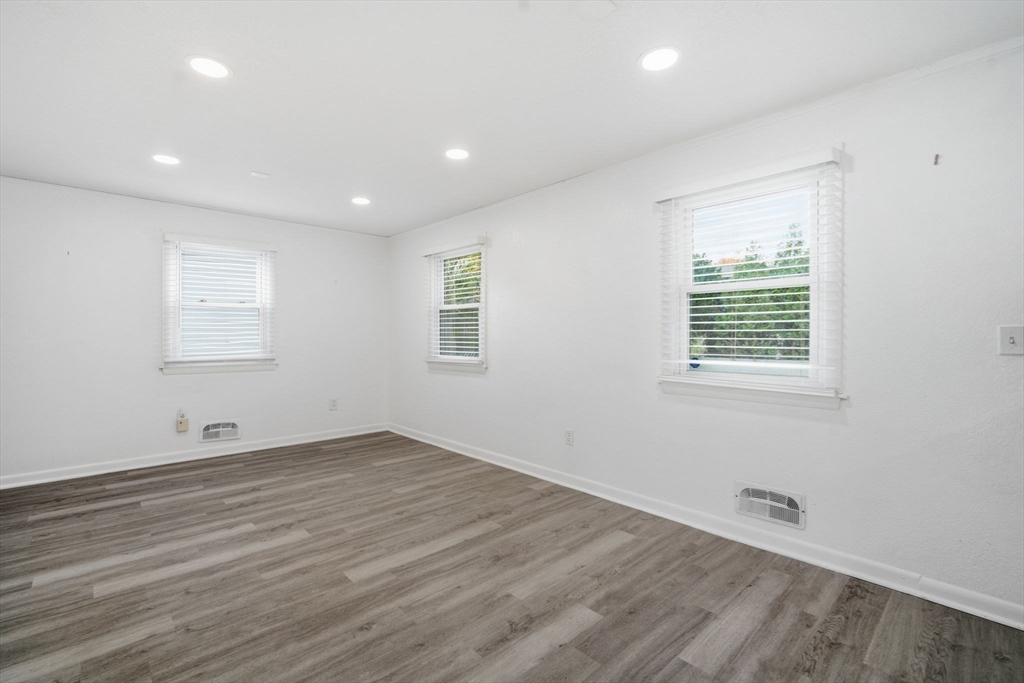181 Beauchamp Terrace Chicopee, MA 01020 - Photo 15 of 36 an empty room with wooden floor and windows