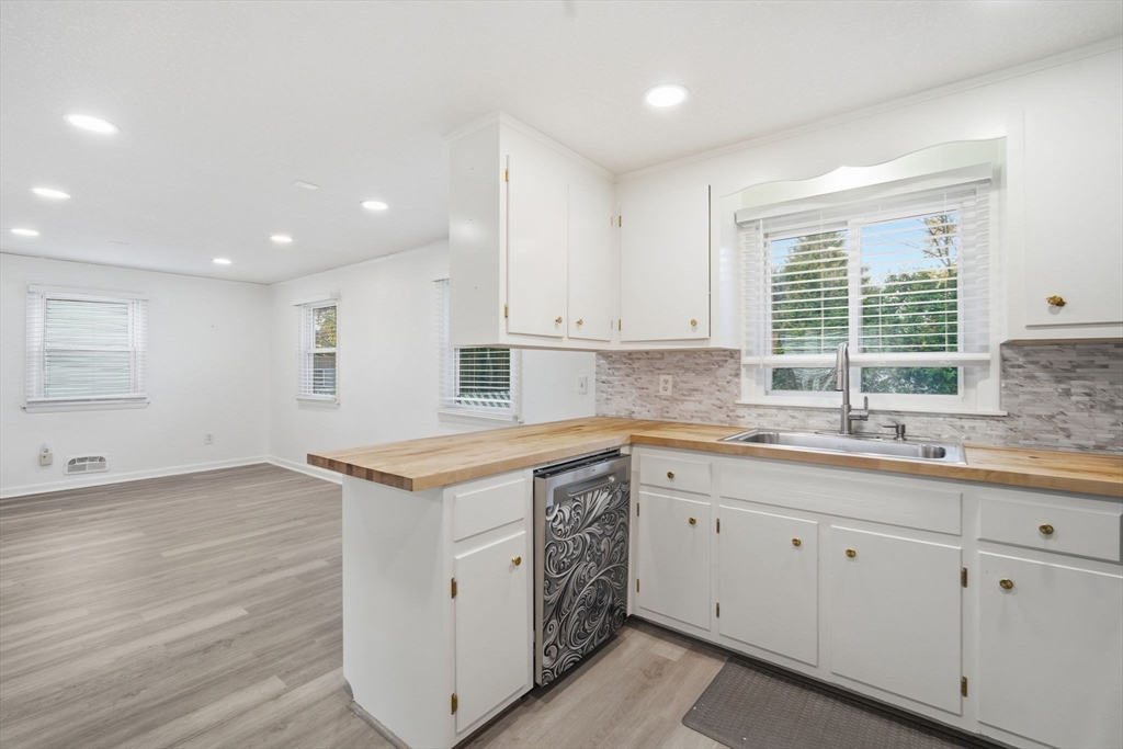 181 Beauchamp Terrace Chicopee, MA 01020 - Photo 7 of 36 a kitchen with a sink window and cabinets