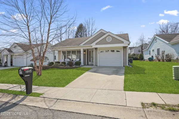 a front view of a house with a garden and plants