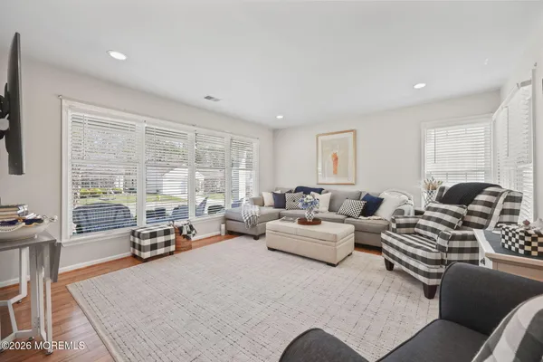 a living room with furniture and flat screen tv