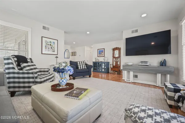 a living room with furniture a table and a large window