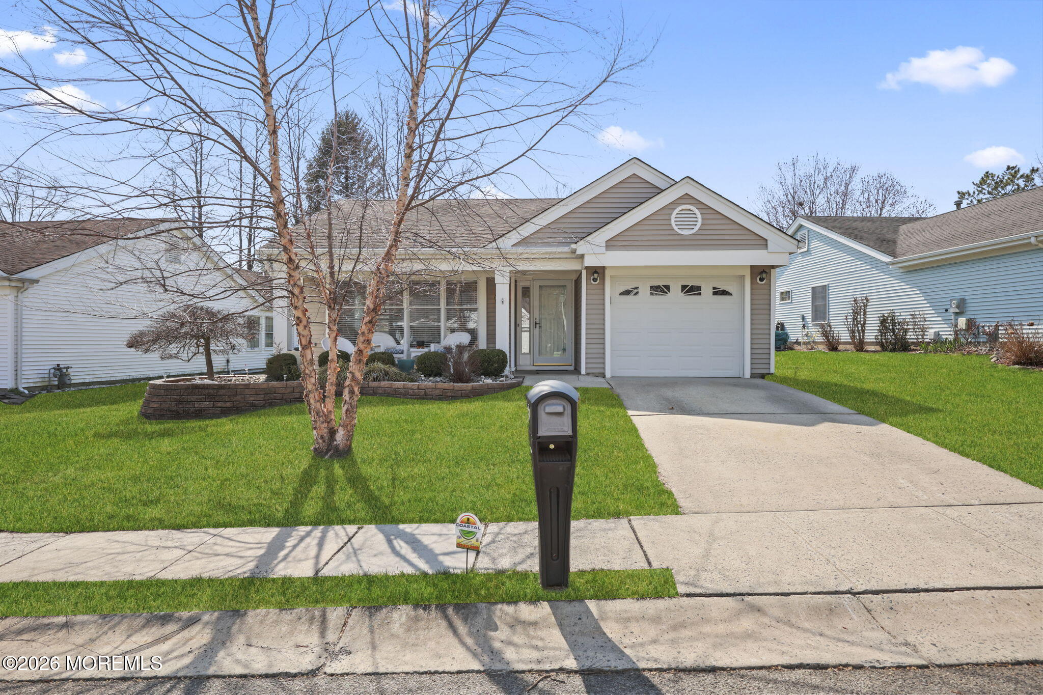 2254 Beltane Road Toms River, NJ 08755 - Photo 2 of 44 a front view of a house with a garden and trees