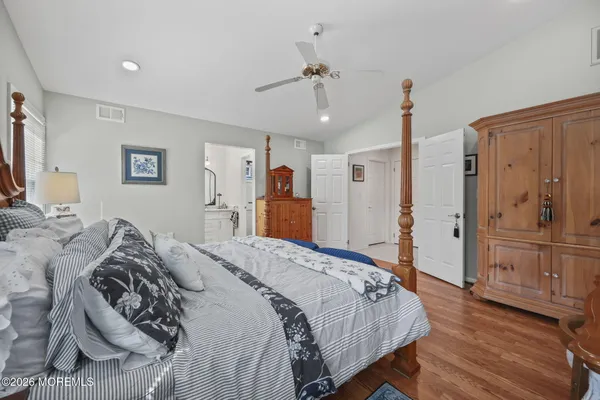 a bathroom with a granite countertop sink a toilet and shower