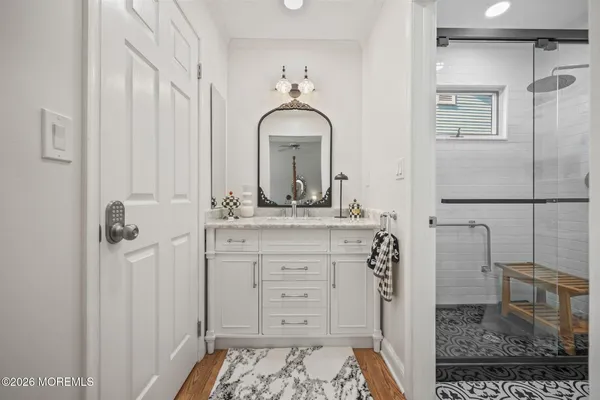 a bathroom with a sink a toilet and shower