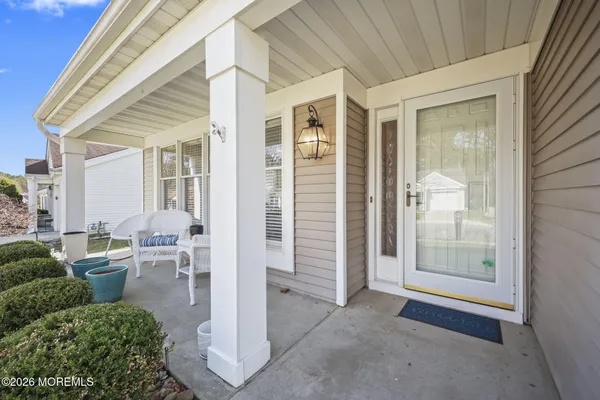 a view of a porch with furniture and garden