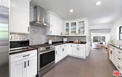 a kitchen with a stove oven and sink