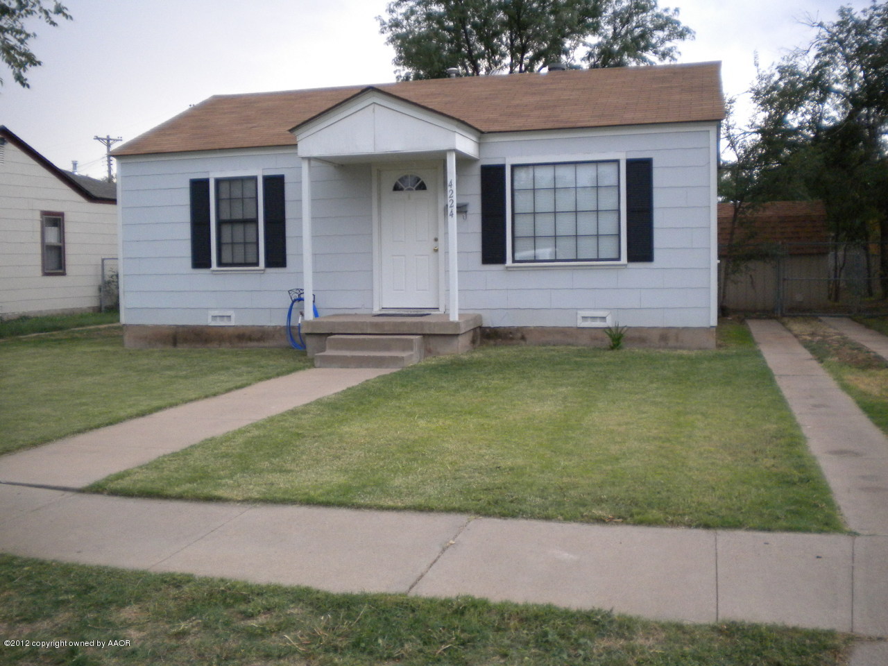 4224 South Harrison Street Amarillo, TX 79110 - Photo 1 of 15 a front view of a house with a garden
