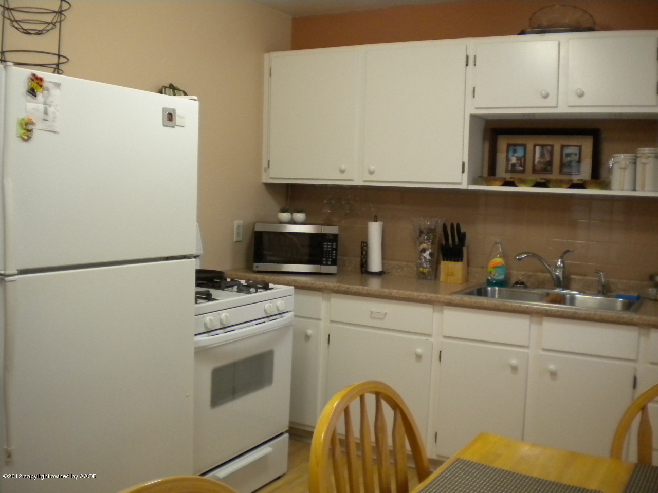 4224 South Harrison Street Amarillo, TX 79110 - Photo 6 of 15 a kitchen with stainless steel appliances white cabinets and a refrigerator
