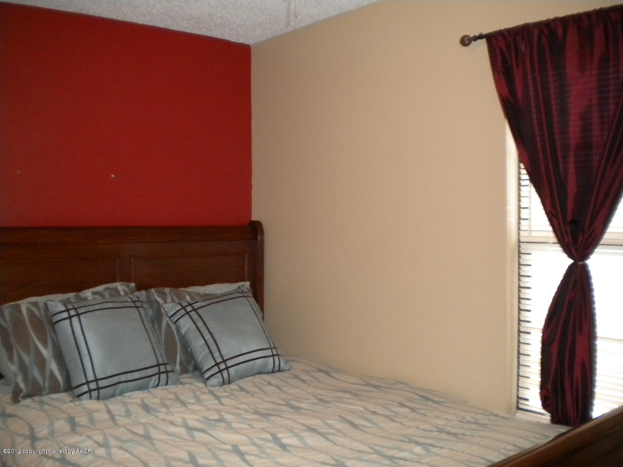 4224 South Harrison Street Amarillo, TX 79110 - Photo 10 of 15 a bed sitting in a bedroom next to a window with wooden floor