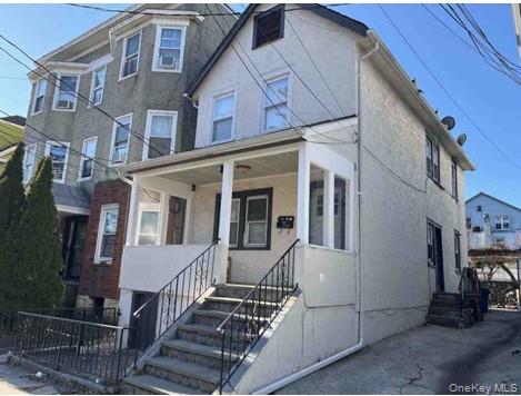 a view of a brick house with many windows