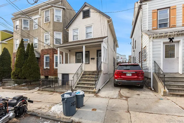 a front view of a house with parking space