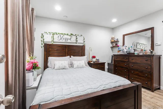 a bedroom with a bed and a dresser