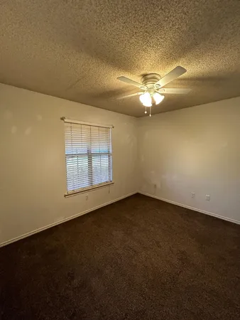 a view of a livingroom with a ceiling fan and window
