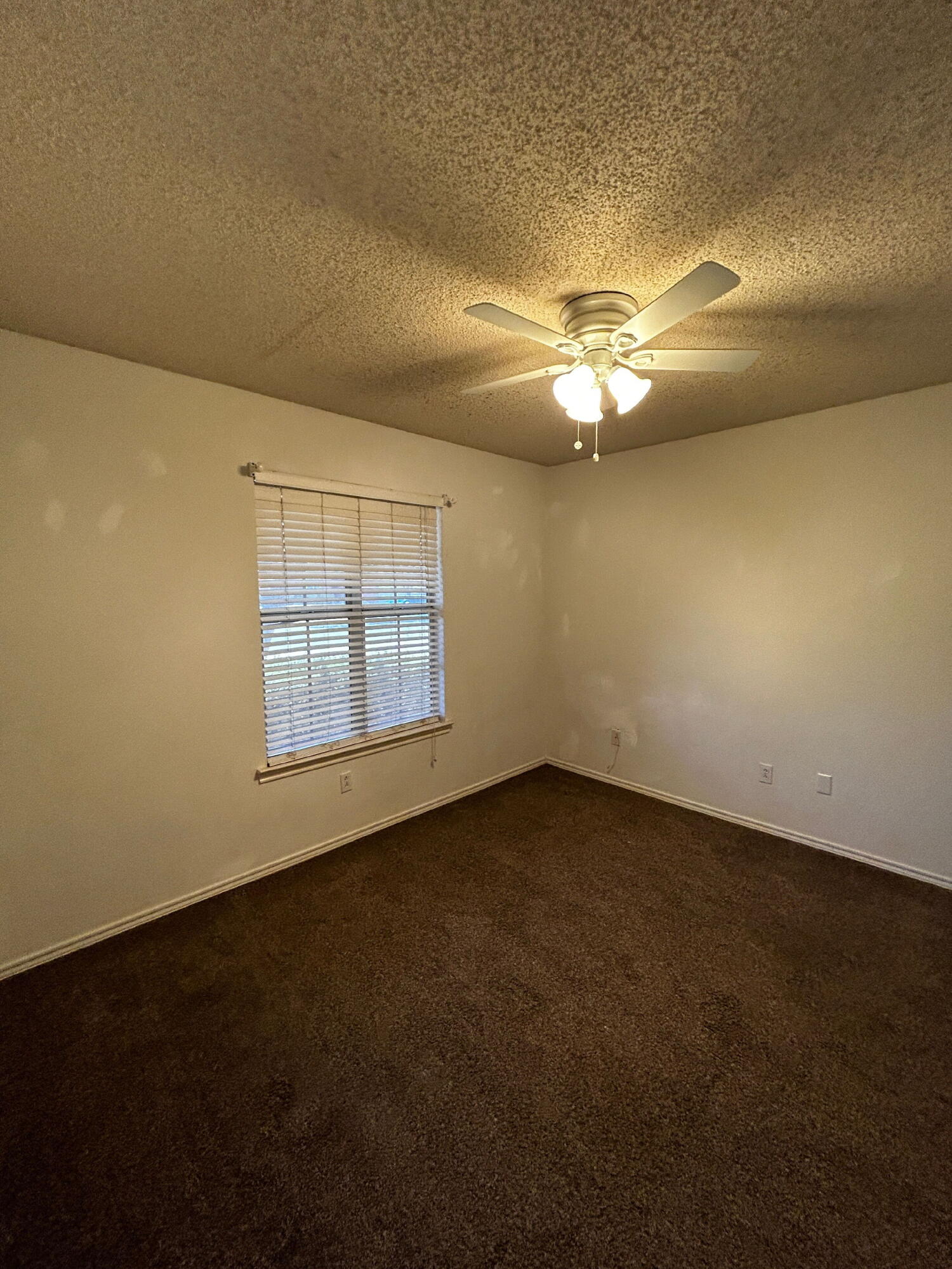 6220 7th Street Lubbock, TX 79416 - Photo 12 of 17 a view of a livingroom with a ceiling fan and window