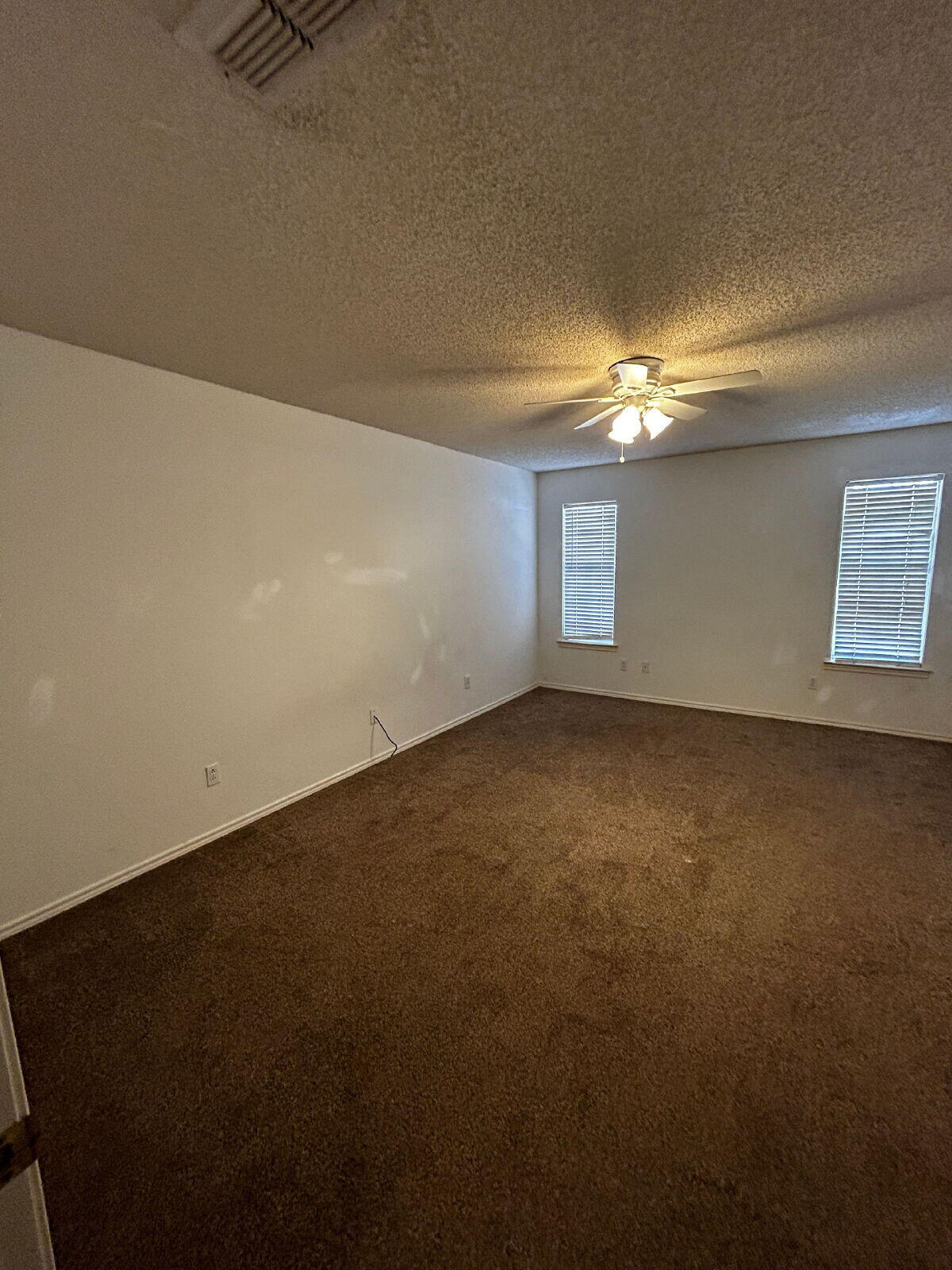 6220 7th Street Lubbock, TX 79416 - Photo 23 of 28 en empty room with windows and fireplace