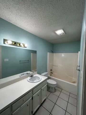 a bathroom with a double vanity sink toilet and mirror