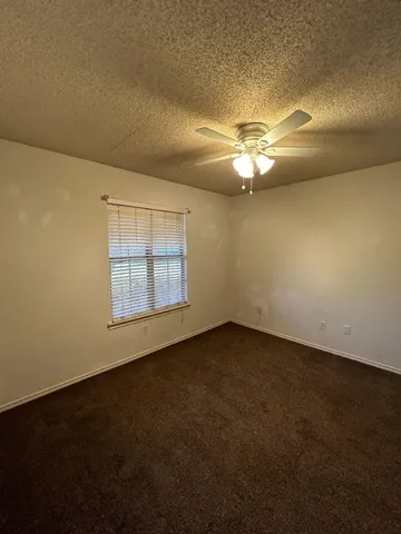 an empty room with a empty space and a ceiling fan