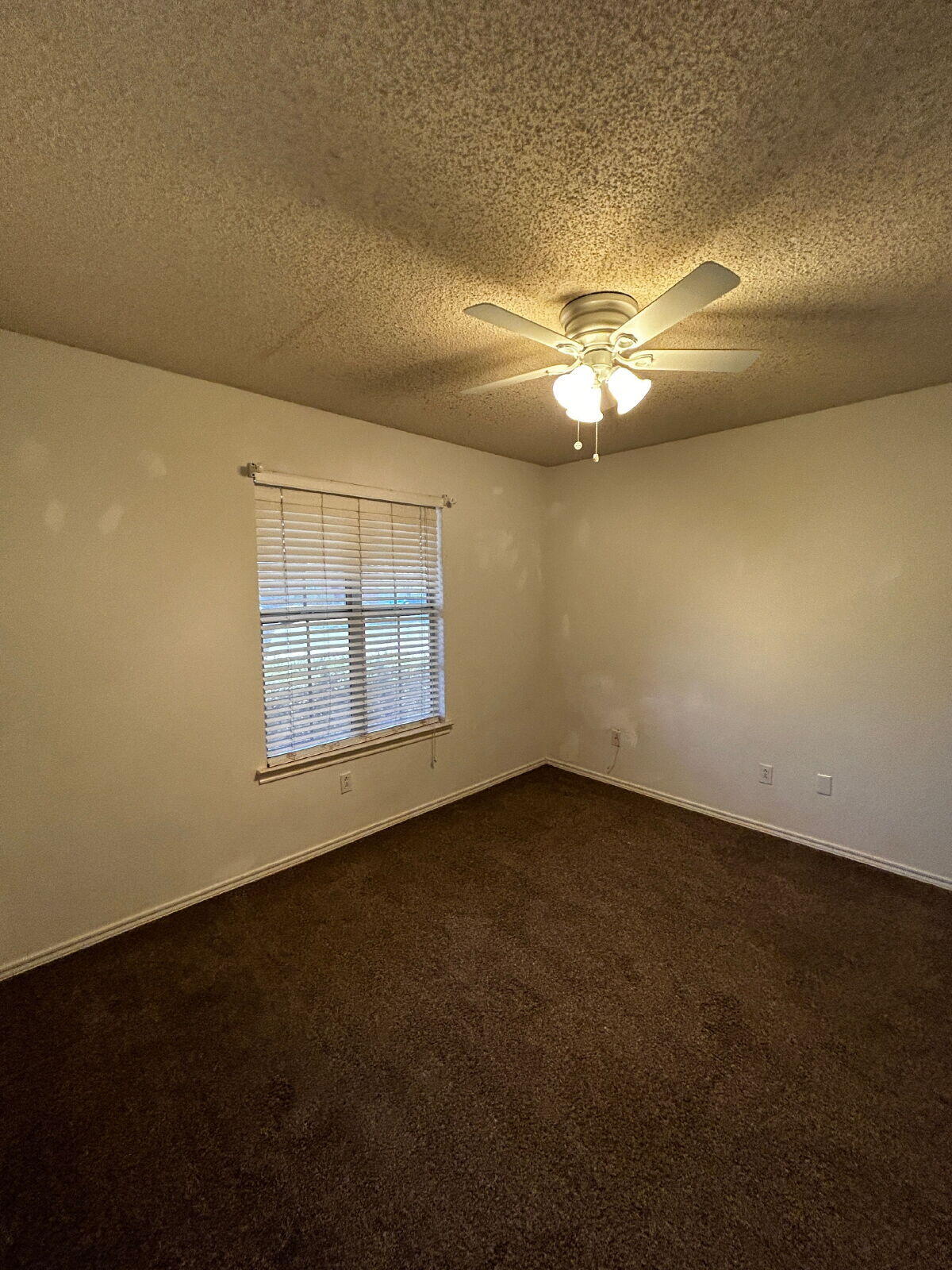 6220 7th Street Lubbock, TX 79416 - Photo 26 of 28 an empty room with a empty space and a ceiling fan