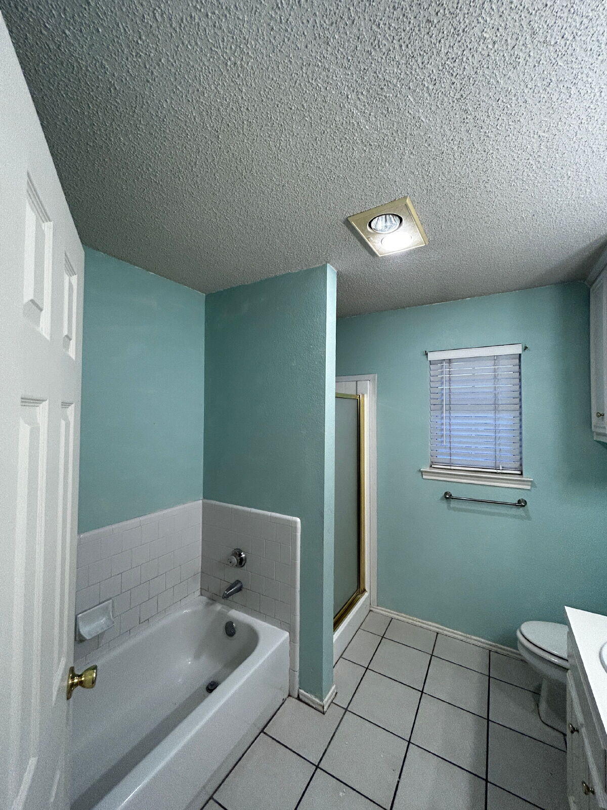 6220 7th Street Lubbock, TX 79416 - Photo 27 of 28 a bathroom with a bathtub and a shower