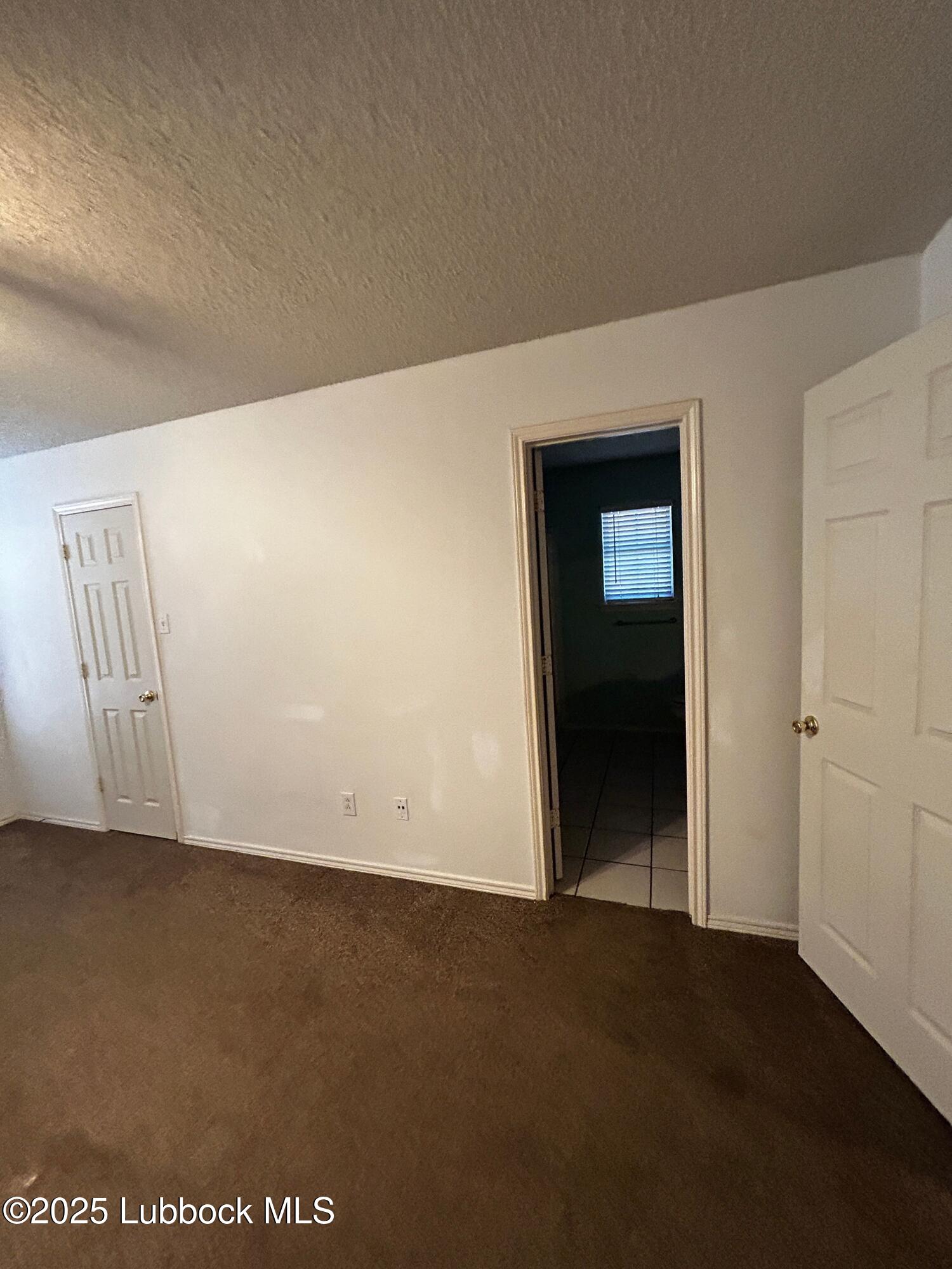 6220 7th Street Lubbock, TX 79416 - Photo 6 of 28 an empty room with closet