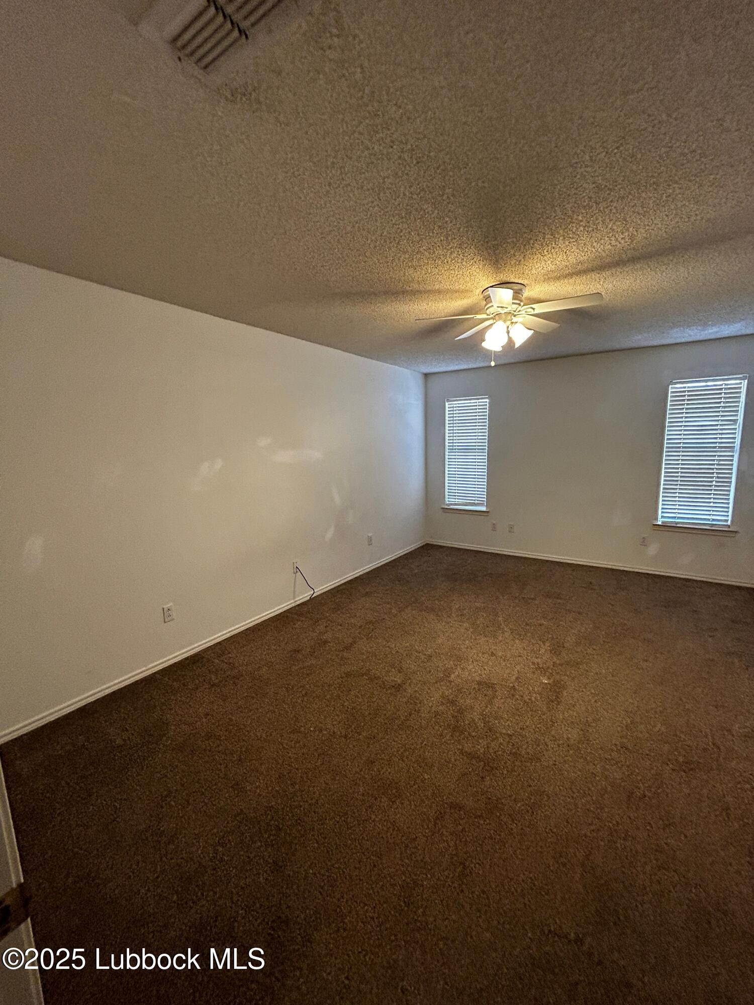 6220 7th Street Lubbock, TX 79416 - Photo 7 of 28 en empty room with windows and yard