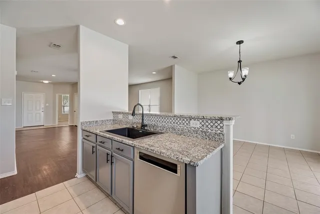 a kitchen with stainless steel appliances granite countertop a sink and stove