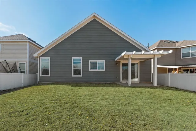 a view of a house with yard and a tree