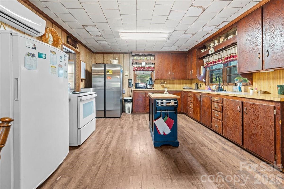 12282 Coyle Road Stanfield, NC 28163 - Photo 8 of 24 a view of a kitchen with furniture and wooden floor