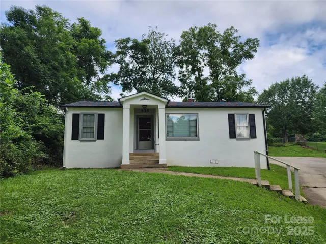 a view of house with backyard and garden