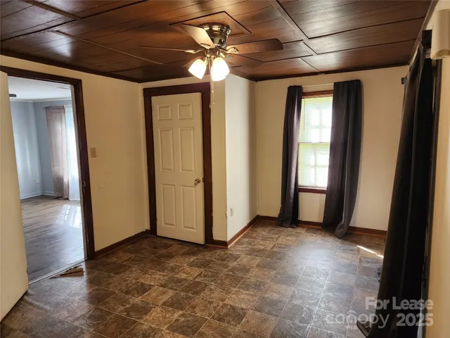 a view of a room with wooden floor