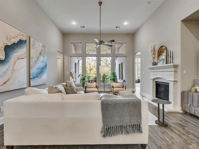 a living room with furniture a large window and a fireplace
