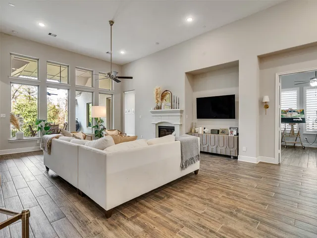 a living room with furniture a flat screen tv and a fireplace